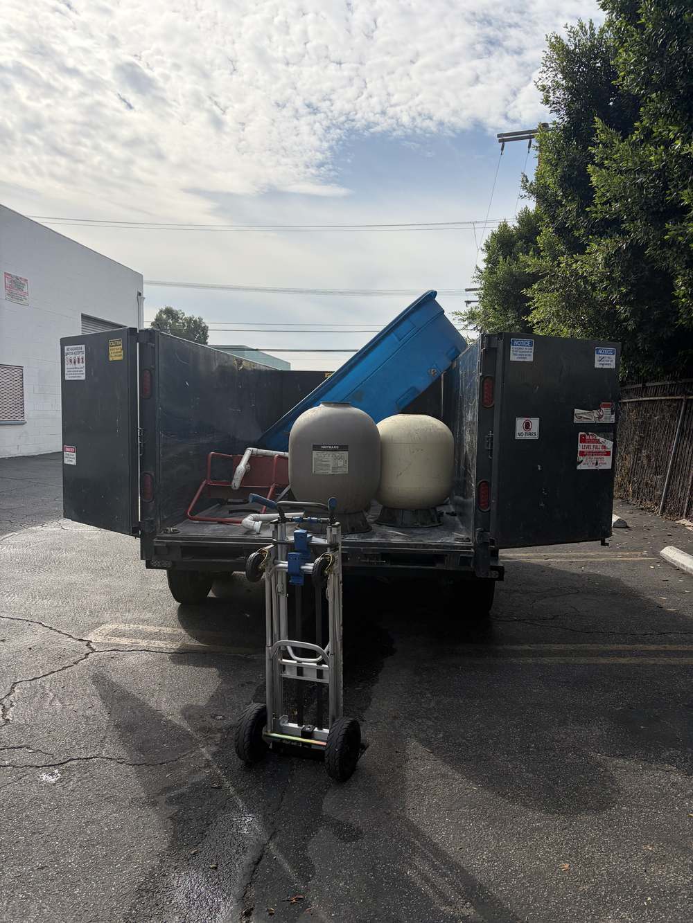 Large pool equipment and tanks loaded for removal